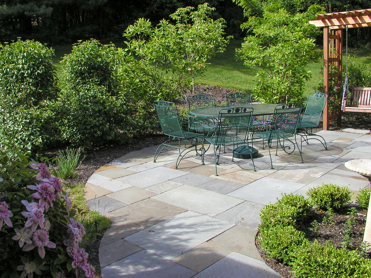 Flagstone patio area with adjacent arbor for a bench swing