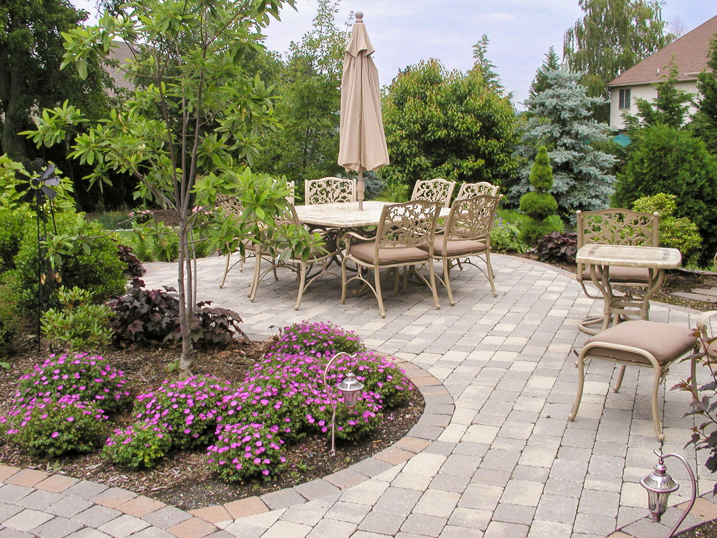 Hardscape and plantings creating outdoor living dining niche destination
